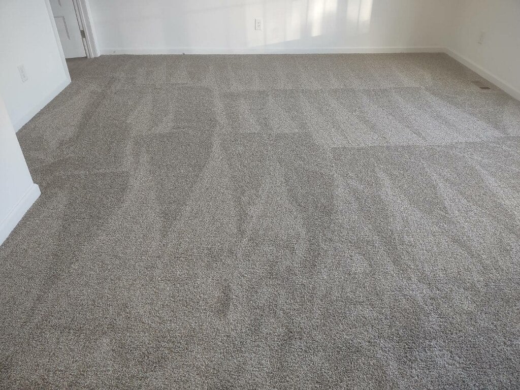 Carpet flooring installed in Charlotte NC bedroom with plush texture and clean seams